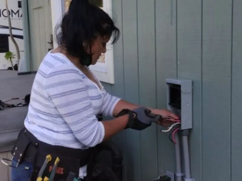 Licensed electrician wiring an exterior subpanel in Midway South